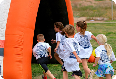 Students in Apex shirts running laps at an Apex Fun Run