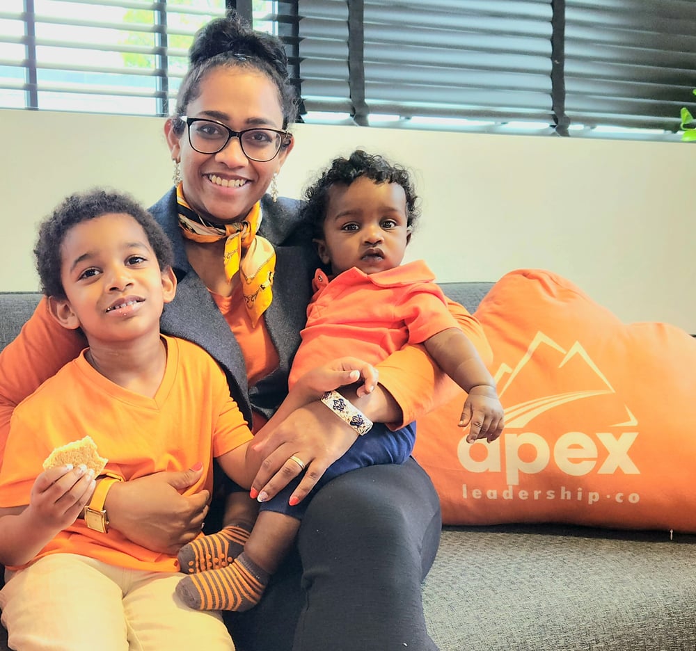 Saswathi Natta, owner of Apex Leadership Co. Potomac, with her two kids in Apex orange