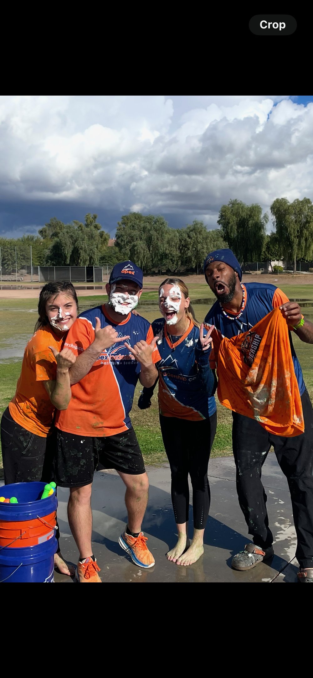 Apex Greater Arizona coaches with whipped cream on their faces after a school celebration