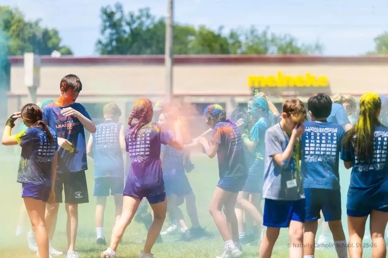 Middle school students playing in color powder at an Apex Color Games event